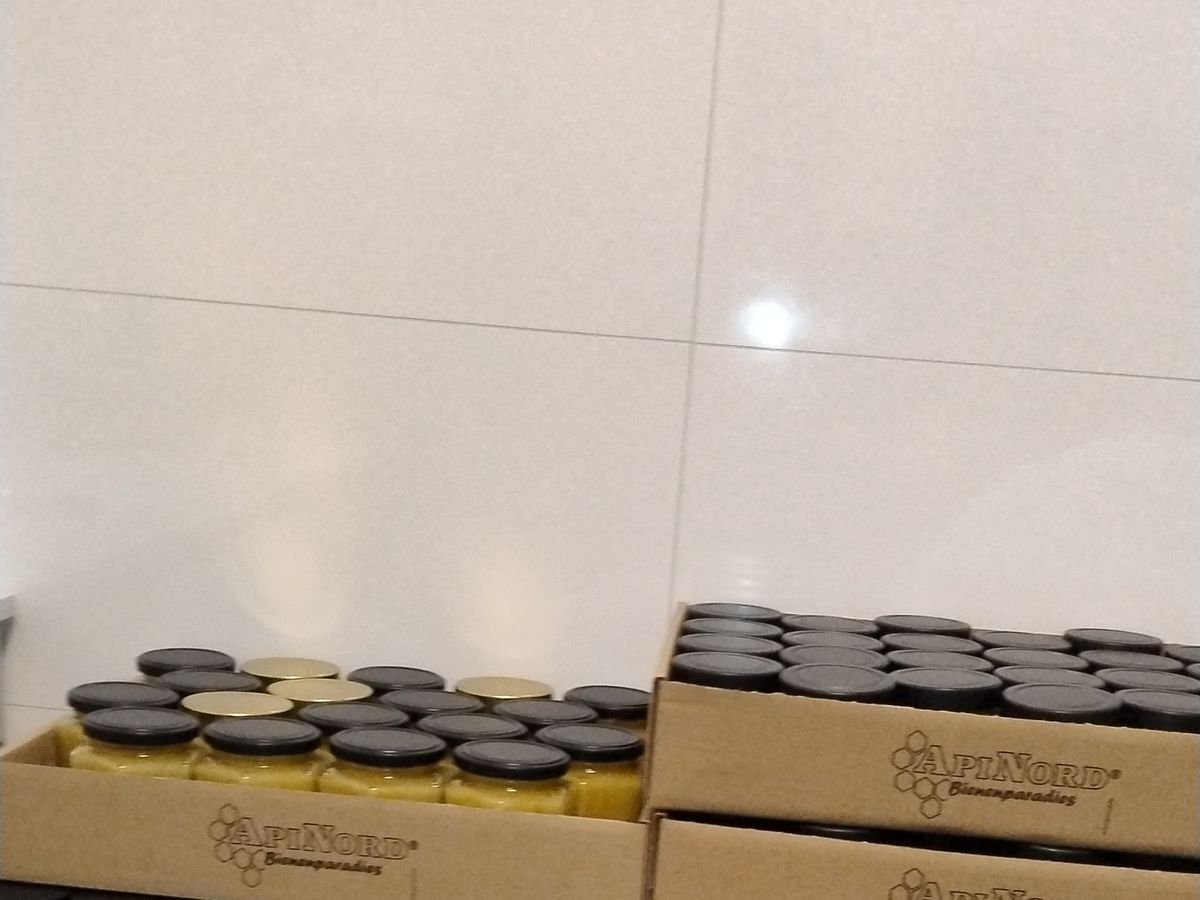 Cases of empty glass jars ready for the next batch of honey