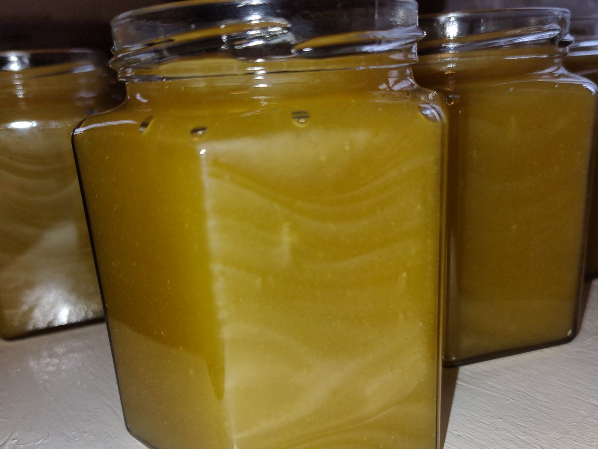 Freshly filled jars of raw honey, not yet labelled